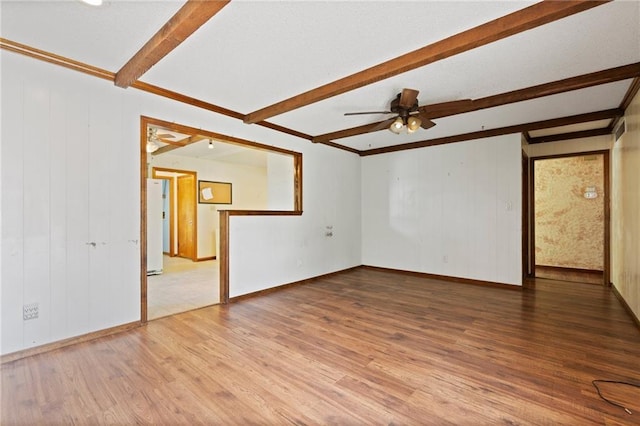 515 London Way, Belton, MO 64012 - spare room with beam ceiling, wood finished floors, a ceiling fan, and baseboards