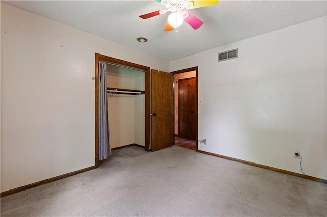 515 London Way, Belton, MO 64012 - unfurnished bedroom featuring light colored carpet, baseboards, a closet, a textured ceiling, and a ceiling fan
