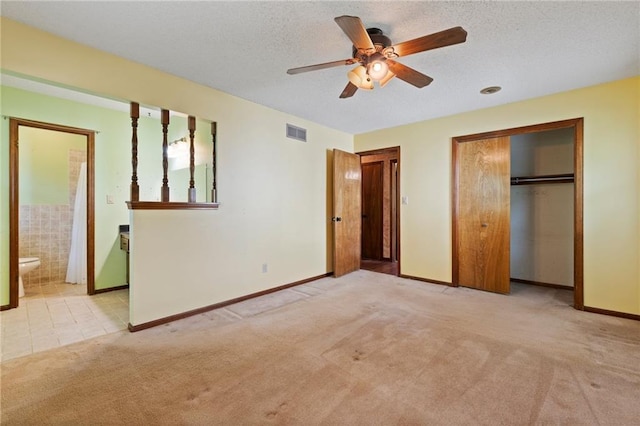 515 London Way, Belton, MO 64012 - unfurnished bedroom with carpet flooring, baseboards, ensuite bath, a textured ceiling, and a ceiling fan