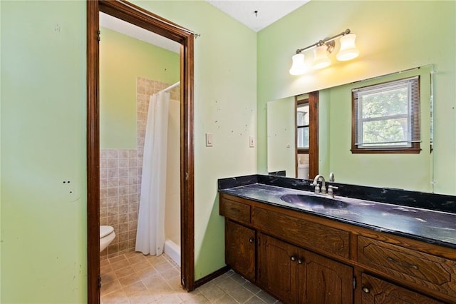 515 London Way, Belton, MO 64012 - bathroom featuring toilet, tile patterned floors, vanity, curtained shower, and tile walls