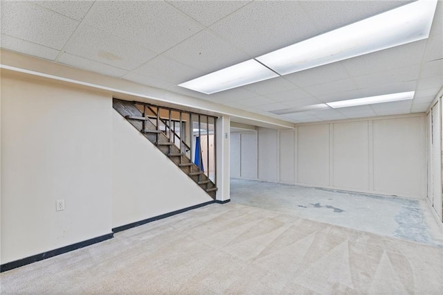 515 London Way, Belton, MO 64012 - finished below grade area with a paneled ceiling, stairway, and carpet flooring