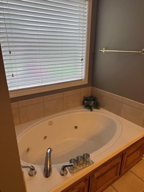 bathroom featuring tile patterned floors and a tub with jets