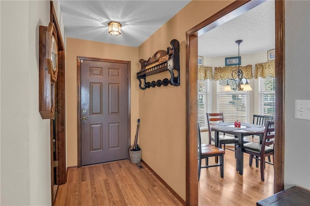 16611 E 53rd St, Independence, MO 64055 - entryway featuring a textured ceiling, light wood-style flooring, and baseboards