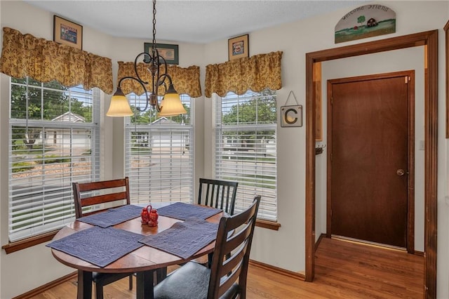 16611 E 53rd St, Independence, MO 64055 - dining area featuring a chandelier, light wood finished floors, healthy amount of natural light, and a textured ceiling