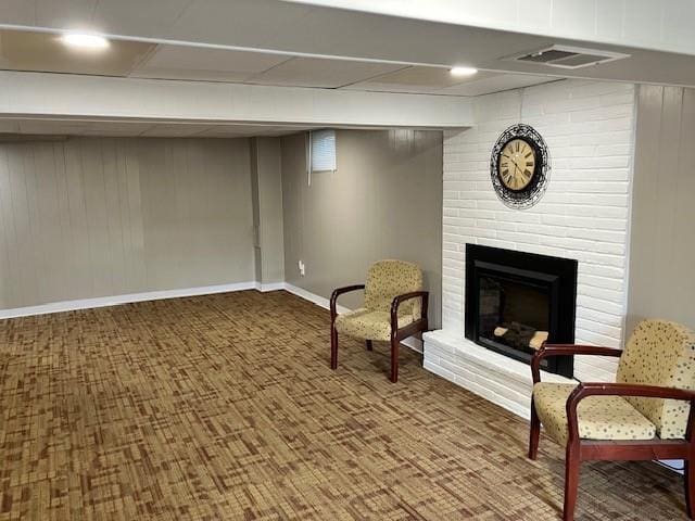 unfurnished room with visible vents, a fireplace, and baseboards