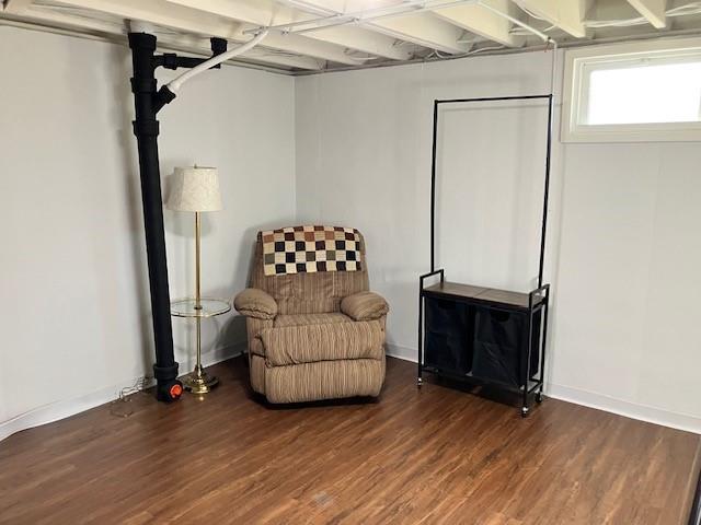sitting room with wood finished floors and baseboards