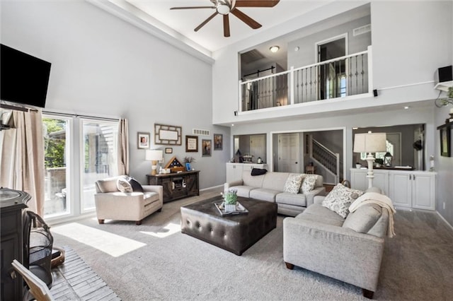 17201 NE 136th St, Kearney, MO 64060 - living room with a ceiling fan, a towering ceiling, carpet floors, stairway, and a wood stove