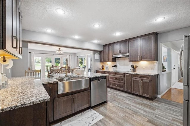 17201 NE 136th St, Kearney, MO 64060 - kitchen featuring stainless steel appliances, a textured ceiling, light stone countertops, dark brown cabinets, and tasteful backsplash