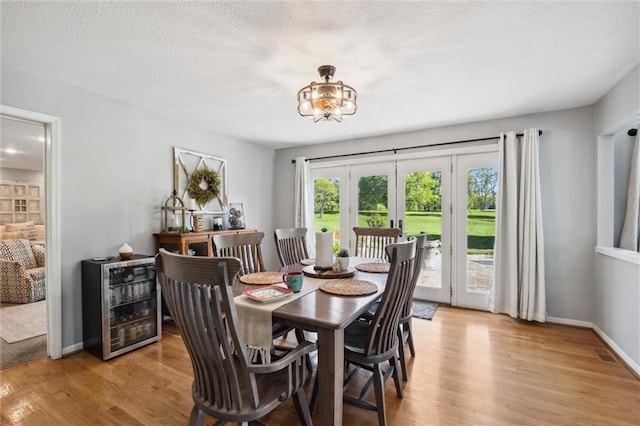 17201 NE 136th St, Kearney, MO 64060 - dining room with beverage cooler, light wood finished floors, and french doors