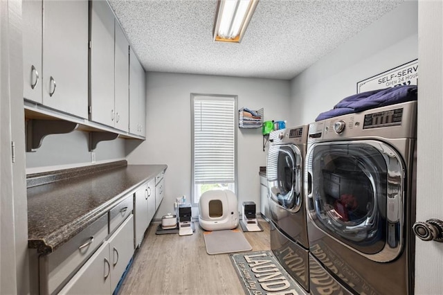 17201 NE 136th St, Kearney, MO 64060 - laundry area with washing machine and clothes dryer, cabinet space, light wood finished floors, and a textured ceiling
