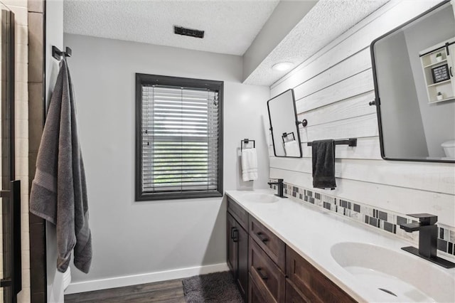 17201 NE 136th St, Kearney, MO 64060 - bathroom featuring double vanity, wood finished floors, and a textured ceiling