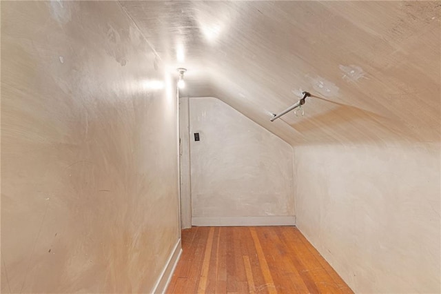bonus room featuring vaulted ceiling and wood finished floors