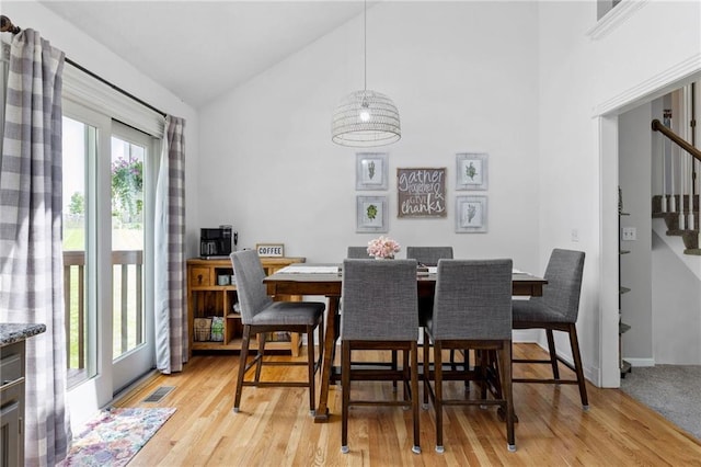 11004 N Kentucky Pl, Kansas City, MO 64157 - dining room featuring stairway, light wood-style flooring, and high vaulted ceiling