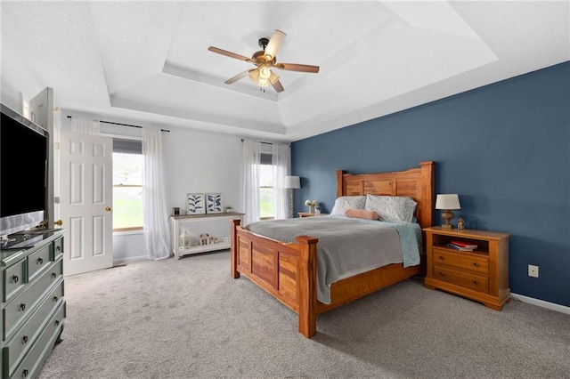 11004 N Kentucky Pl, Kansas City, MO 64157 - carpeted bedroom with a tray ceiling, baseboards, and a ceiling fan