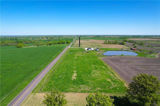 birds eye view of property featuring a water view and a rural view