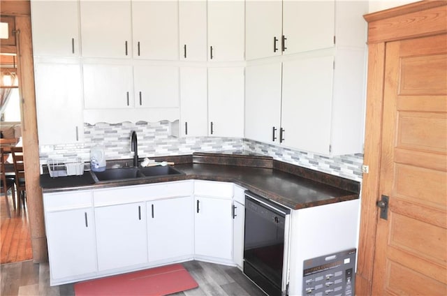 kitchen with a sink, wood finished floors, tasteful backsplash, and dishwasher