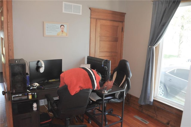 office area featuring visible vents and wood finished floors