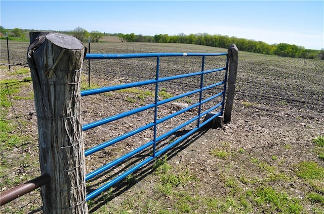 view of gate featuring a rural view and fence