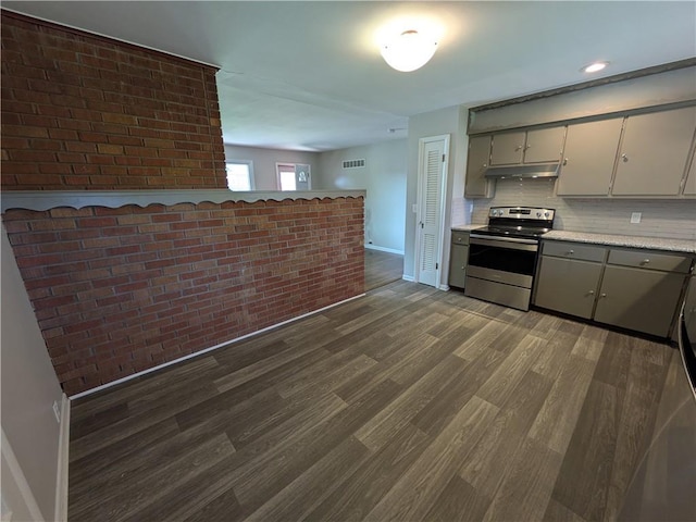 kitchen with stainless steel range with electric cooktop, under cabinet range hood, baseboards, dark wood-type flooring, and light countertops