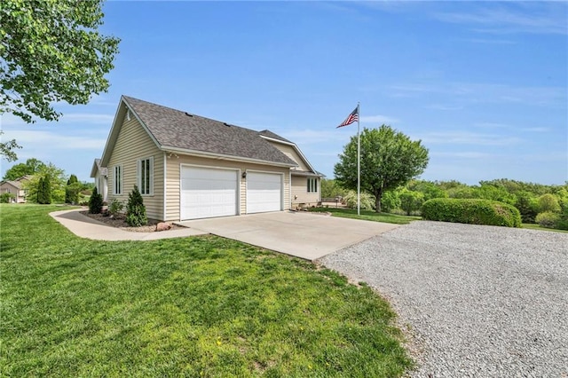 view of side of property featuring concrete driveway, a garage, and a lawn