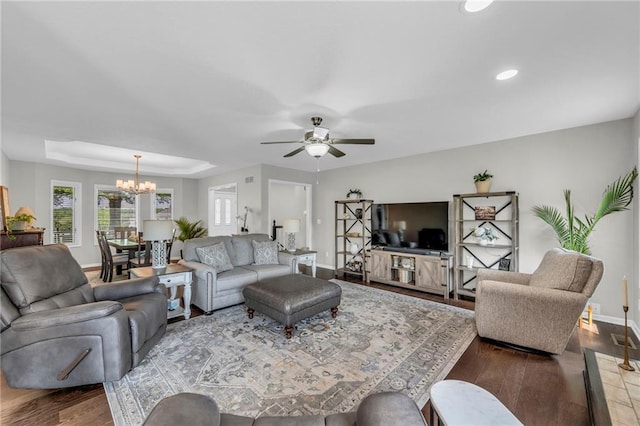 living area featuring a chandelier, baseboards, a ceiling fan, wood finished floors, and recessed lighting