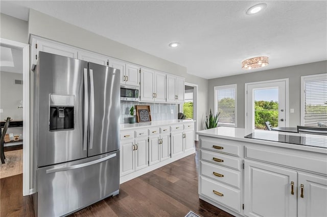 kitchen with appliances with stainless steel finishes, white cabinetry, light countertops, dark wood-style flooring, and recessed lighting