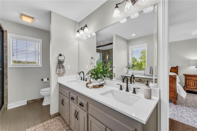 full bathroom featuring ensuite bath, double vanity, baseboards, toilet, and an enclosed shower