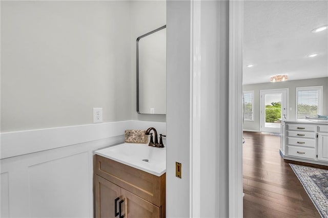 bathroom featuring vanity, wood finished floors, and recessed lighting