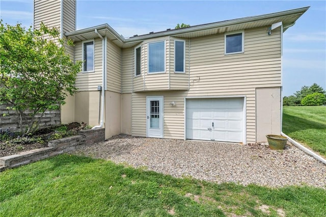 view of front of property with an attached garage, a front yard, a chimney, and driveway