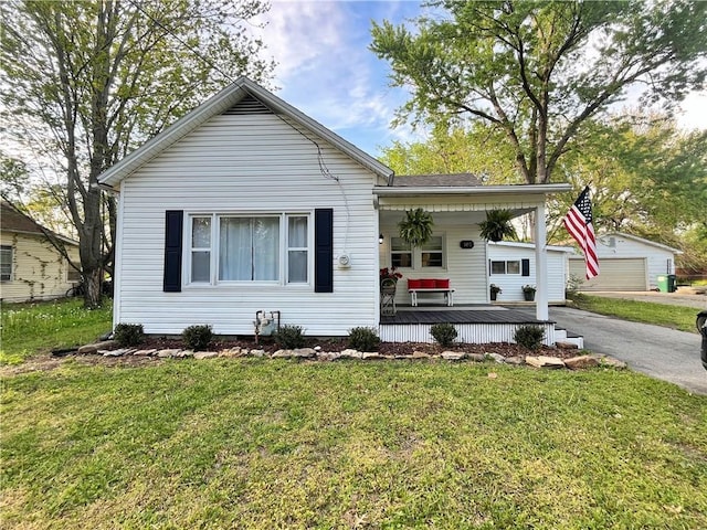 bungalow-style house with a front yard and covered porch