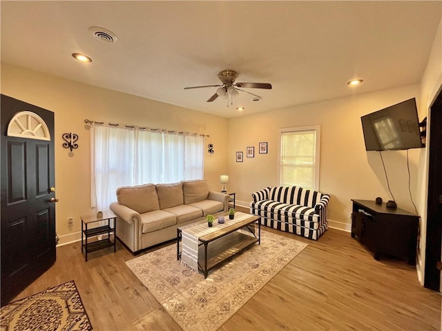 living area with light wood finished floors, baseboards, a ceiling fan, and recessed lighting
