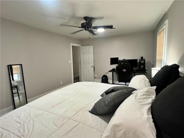 bedroom featuring baseboards and a ceiling fan
