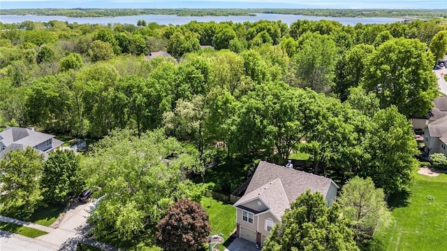 aerial view with a wooded view and a water view