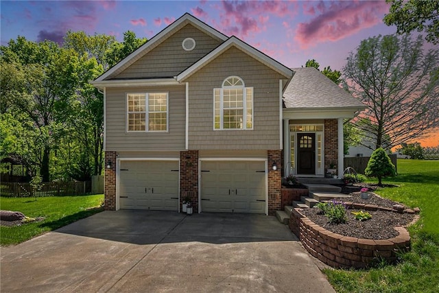 view of front of house with a yard, brick siding, and an attached garage