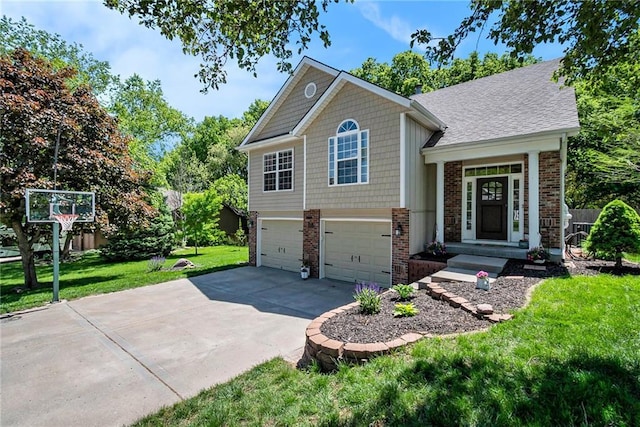 split level home with brick siding, concrete driveway, a garage, a front lawn, and a shingled roof