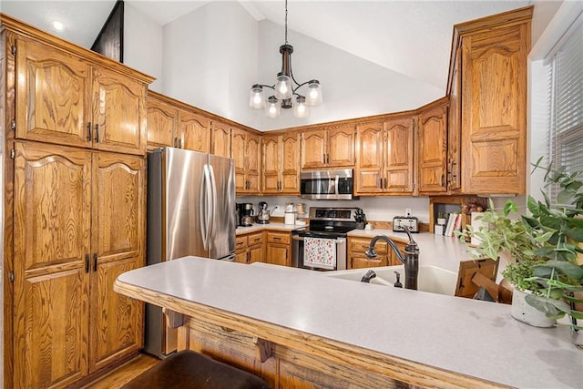 kitchen with a sink, brown cabinetry, decorative light fixtures, a notable chandelier, and appliances with stainless steel finishes