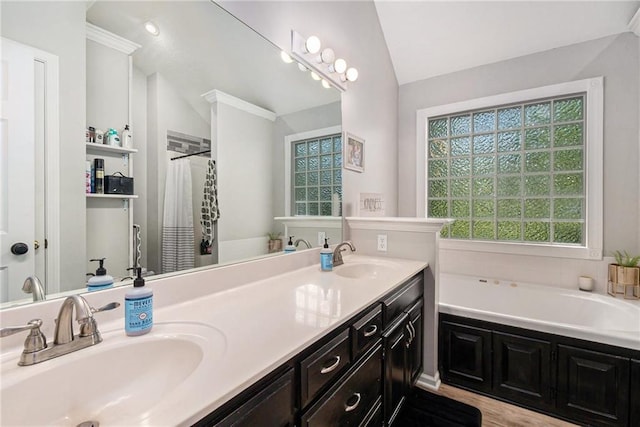 full bathroom with a bath, double vanity, a sink, and vaulted ceiling