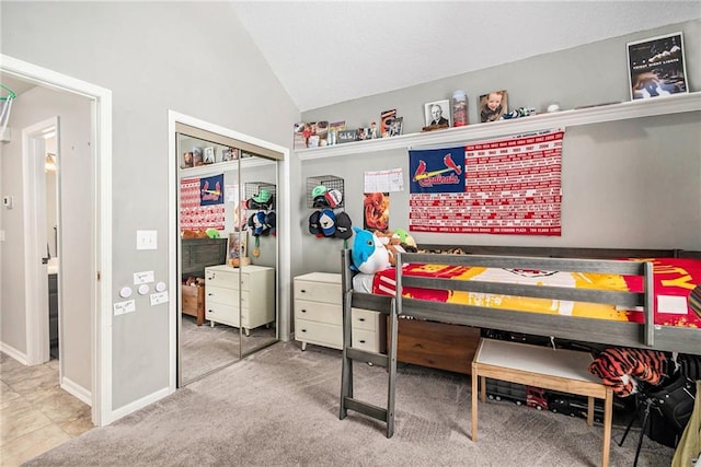 bedroom with baseboards, a closet, and vaulted ceiling