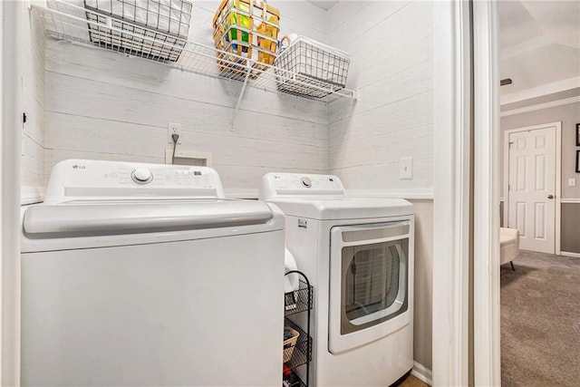 laundry area featuring carpet flooring, laundry area, wooden walls, and separate washer and dryer