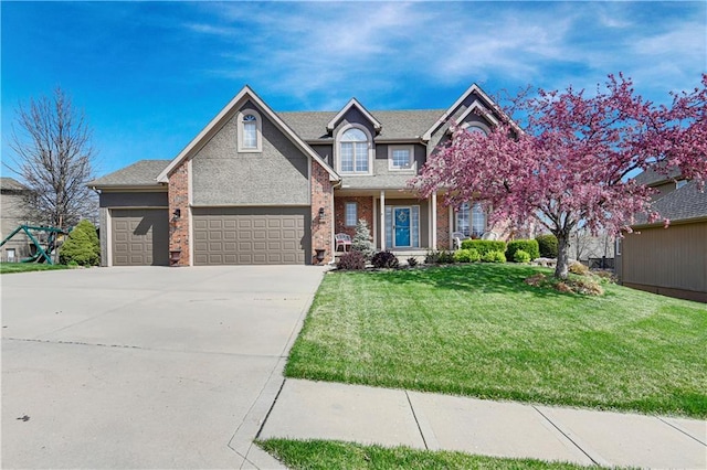 8904 NE 94th Pl, Kansas City, MO 64157 - view of front facade with a front yard, driveway, an attached garage, and brick siding