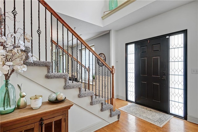 8904 NE 94th Pl, Kansas City, MO 64157 - foyer featuring wood finished floors, stairway, and baseboards