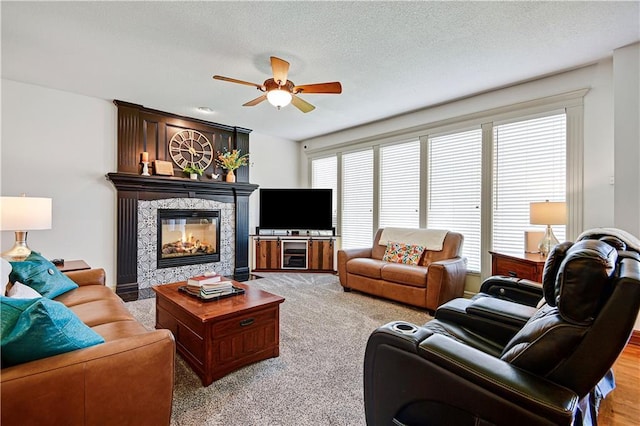 8904 NE 94th Pl, Kansas City, MO 64157 - living area featuring ceiling fan, a fireplace, and a textured ceiling