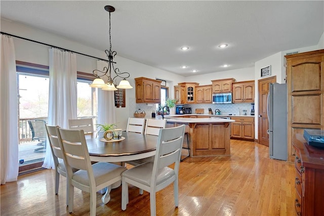 8904 NE 94th Pl, Kansas City, MO 64157 - dining area featuring light wood finished floors, a chandelier, and recessed lighting