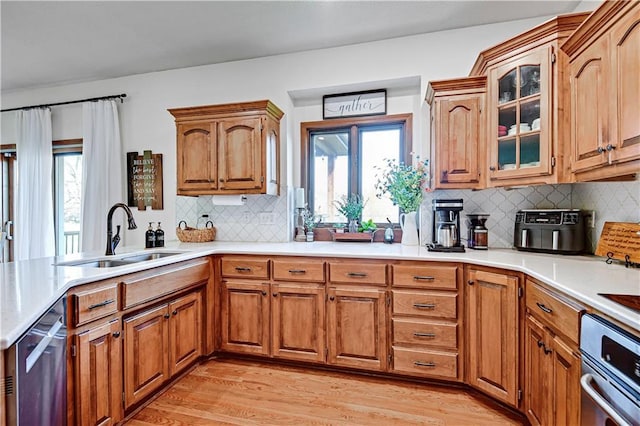 8904 NE 94th Pl, Kansas City, MO 64157 - kitchen featuring a sink, brown cabinetry, and light wood-style flooring
