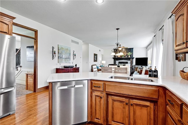 8904 NE 94th Pl, Kansas City, MO 64157 - kitchen featuring appliances with stainless steel finishes, open floor plan, light countertops, and a sink
