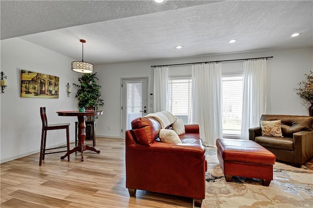 8904 NE 94th Pl, Kansas City, MO 64157 - living room with light wood finished floors, a textured ceiling, recessed lighting, and baseboards