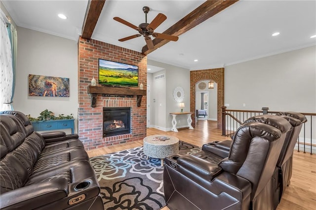 living area with ceiling fan, wood finished floors, a fireplace, beamed ceiling, and recessed lighting