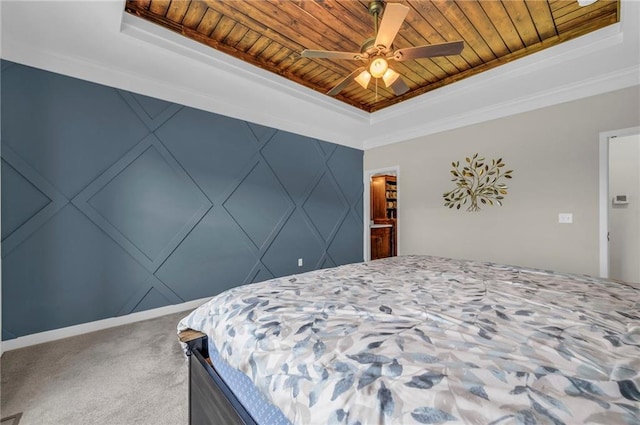 bedroom with a tray ceiling, wood ceiling, carpet flooring, ornamental molding, and ceiling fan