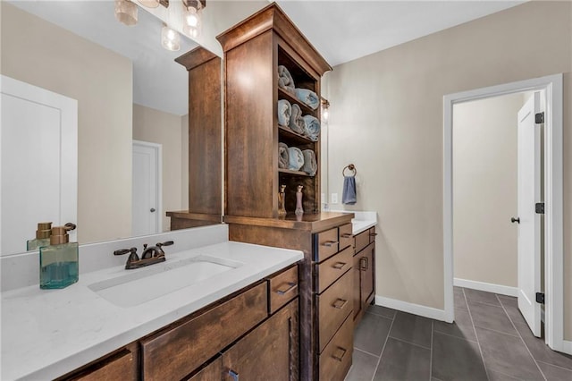 full bath with tile patterned floors, vanity, and baseboards