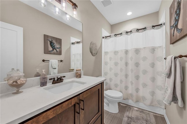 bathroom featuring toilet, vanity, and shower / bath combo with shower curtain